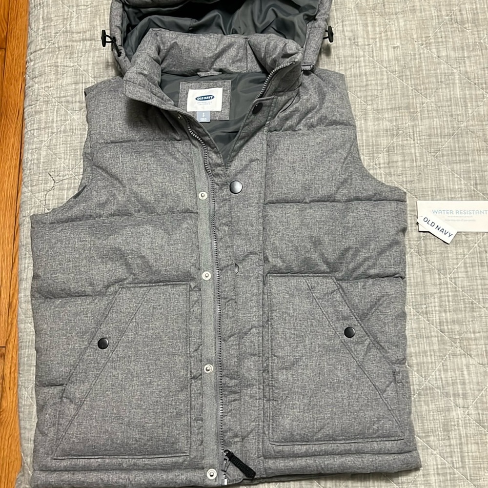 Never worn, puffy vest with hood, tags attached